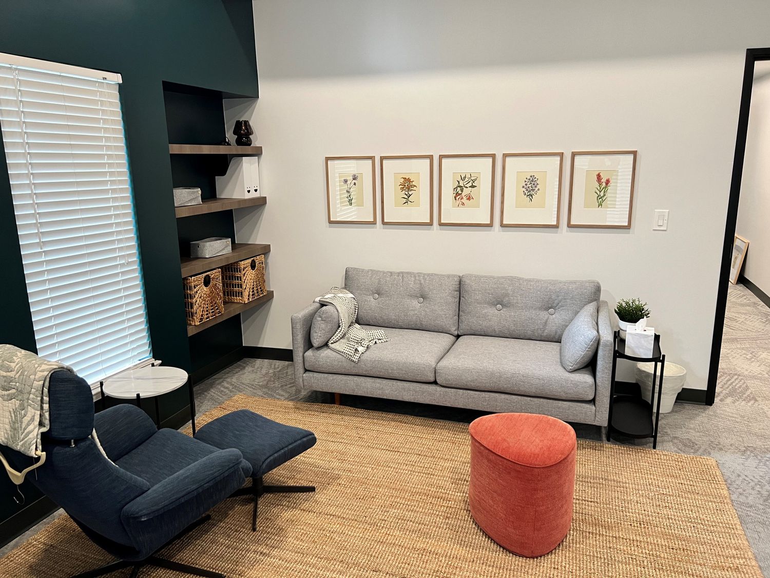 Welcoming waiting room at Addison Therapy Associates with blue and green velvet sofas and colorful artwork